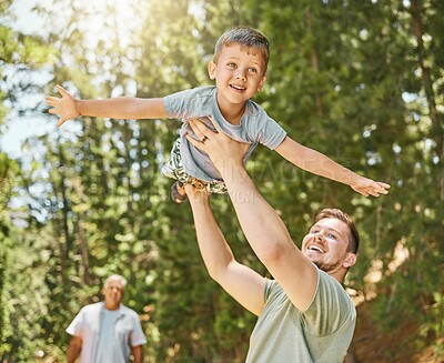 Buy stock photo Hiking, love and a boy flying with his father outdoor in nature while camping in the forest or woods. Family, fun and a young child son playing with his happy dad or parent in the sunny wilderness