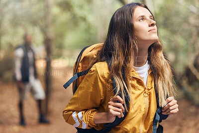 Buy stock photo Wellness, nature and adventure with a female backpacker explore a forest, breathing fresh air and looking around. Young woman enjoying the view of the woods while out hiking and having fun