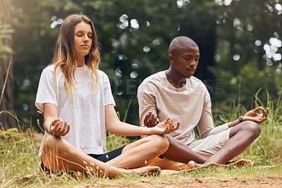 Buy stock photo Yoga, interracial couple and meditation for zen and balance with black man and white woman sitting in lotus at a park in nature. Calm and content with holistic spiritual exercise and health training
