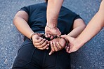 Drug arrest, drugs stealing and criminal man with handcuffs on the ground. Back hands view of legal justice on the road of a caught guy in the act going to court, jail or prison with a police officer