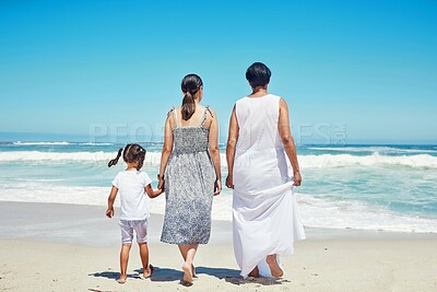 Buy stock photo Children, family and beach with a girl, mother and grandmother enjoying the sea or ocean view while on vacation. Kids, bonding and travel with a woman, parent and daughter on the sand on holiday