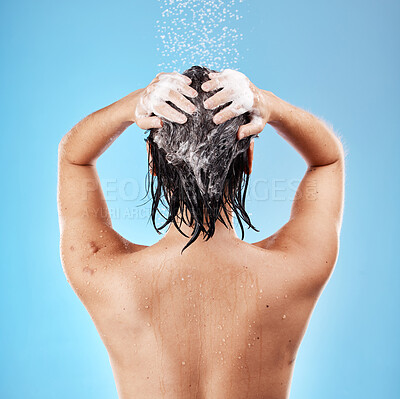 Buy stock photo Shower, hair and shampoo with a woman cleaning using water for haircare in studio on a blue background. Hygiene, water and cleanliness with a female washing for treatment or hydration in the bathroom