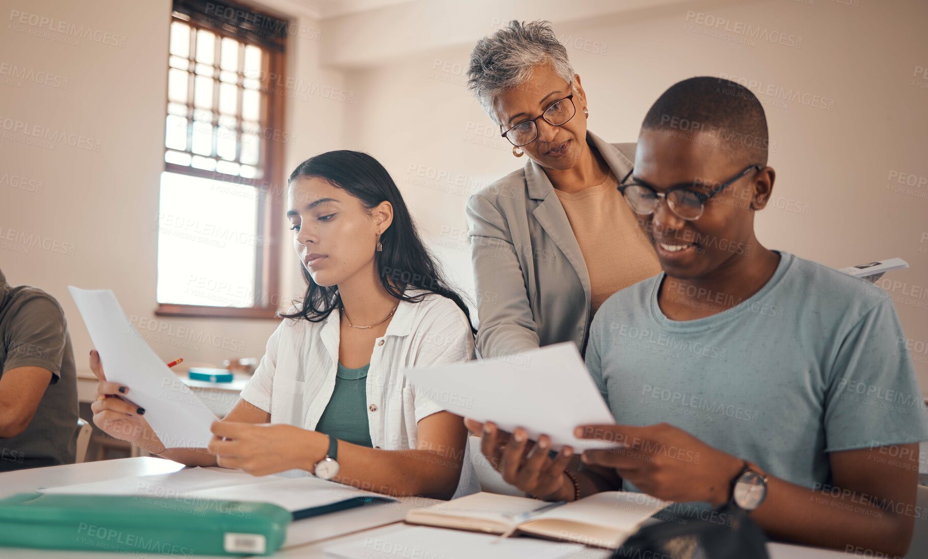 Buy stock photo Student, exam and woman teacher with students in a school education class for writing test. Diversity, study and learning of teenagers reading notes, research and data thinking about scholarship 