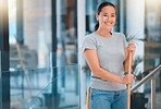 Cleaning, broom and portrait of woman cleaner working in modern office for hygiene and disinfection. Happy, smile and maid or housekeeper disinfecting floor for germs, bacteria and dirt in workplace.