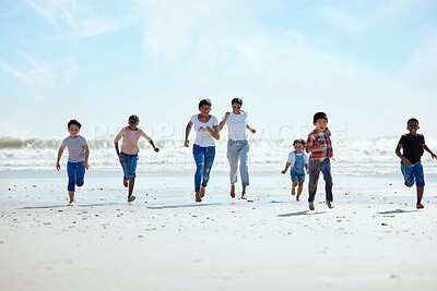 Buy stock photo Summer, beach and a group of children running on sand, friendship and fun on ocean holiday. Friends, kids and energy in youth, happy boys and girls on vacation in playful race together at the sea.
