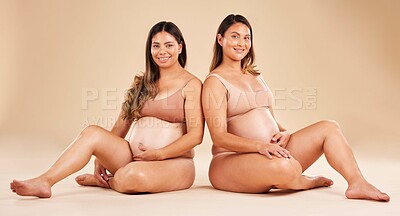 Buy stock photo Women, portrait or sitting and pregnancy stomach, tummy growth progress or baby healthcare wellness on studio background. Smile, happy or friends in pregnant underwear for solidarity support or love