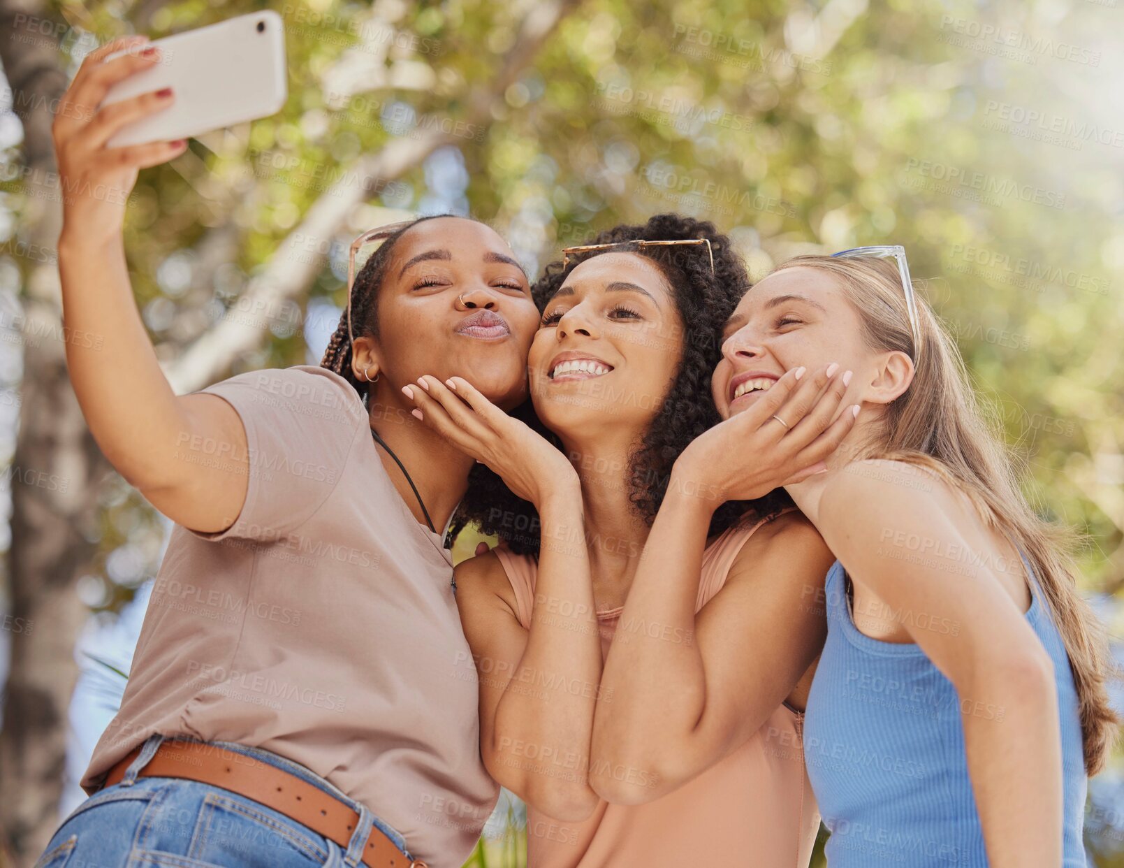 Buy stock photo Selfie, girl friends kiss and bonding of students together with travel and freedom. Outdoor, happiness smile and happy summer vacation taking social media profile picture in a park on holiday