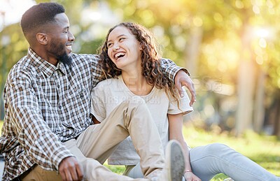 Buy stock photo Happy, relax and interracial couple at a park for a date, quality time and bonding in Australia. Summer, love and black man and a woman in nature, laughing and talking in a relationship together