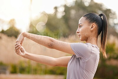 Buy stock photo Fitness, health and woman stretching arms in nature to get ready for workout, training and exercise. Sports, thinking and female stretch hands and warm up to start exercising, cardio and running.