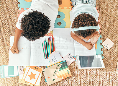 Buy stock photo Kids, home education an online knowledge app with children doing elearning and writing activity. Kid video streaming, school student note book and above of a child and sibling together on the ground 