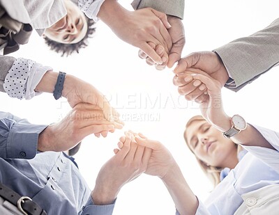 Buy stock photo Business people, holding hands and teamwork for collaboration, trust or unity below in the outdoors. Group of employees touching hand together for community, team building or partnership in nature