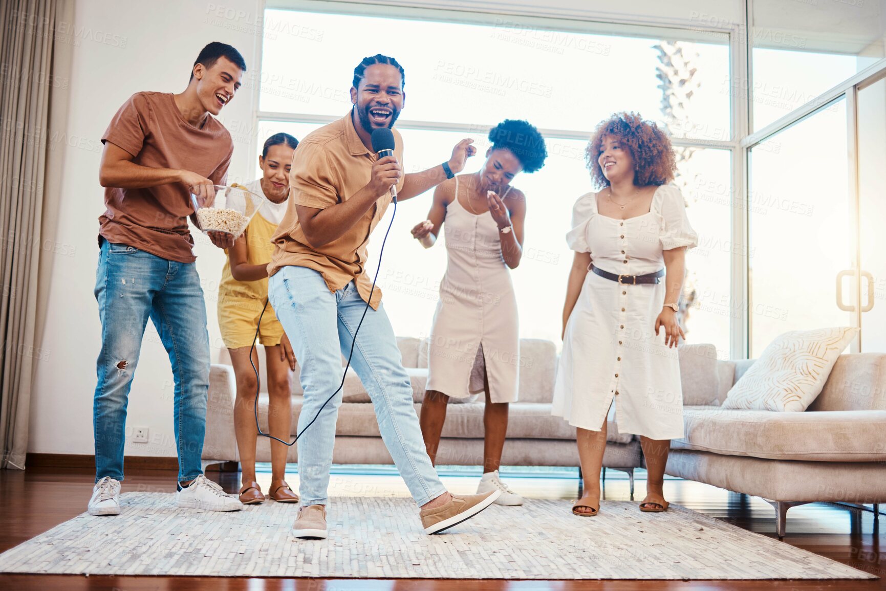 Buy stock photo Energy, entertainment and friends singing karaoke in the living room with a microphone to music, playlist or radio. Happy, diversity and young people dancing, bonding and having fun together at home.