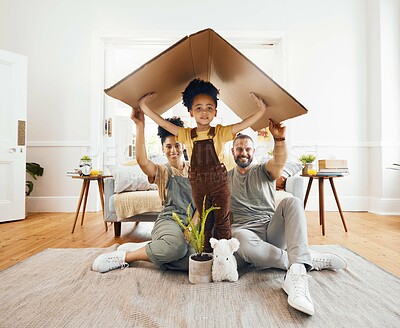 Portrait, family and a boy with cardboard for insurance in the living room of their home together. Mother, father and son in a house for security or safety in real estate and property finance