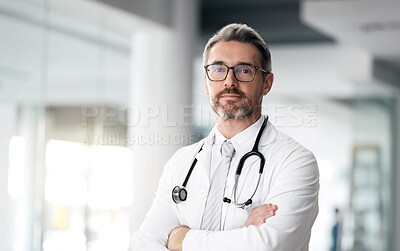 Buy stock photo Serious doctor, portrait and man with arms crossed in hospital for healthcare, wellness or career. Face, medical professional and confident surgeon, expert and mature employee in glasses in Canada