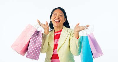 Buy stock photo Woman, winner and shopping bag for discount, sale and retail giveaway or competition isolated on a white background. Portrait of an excited asian customer with gift, winning or celebration in studio
