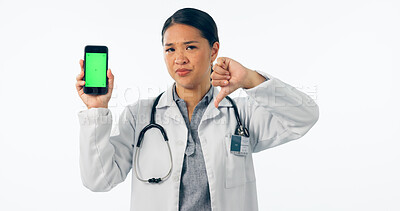 Buy stock photo Doctor, thumbs down and phone green screen for healthcare mistake, bad results and nope mockup in studio. Portrait of medical woman with mobile and wrong, fail or dislike isolated on white background