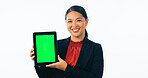 Portrait of business woman, green screen and tablet for advertising space, offer and mockup newsletter in studio. Happy asian worker show digital announcement, launch or promotion on white background