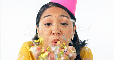 Buy stock photo Woman, party hat and blow confetti for birthday celebration, happy and excited in studio mockup. Asian person, smile and festive for winner of prize, giveaway and congratulations by white background 