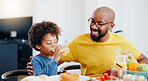 Happy, breakfast and father eating with child in dining room at modern home together for bonding. Smile, love and African dad enjoying healthy morning food and juice with boy kid at family house.