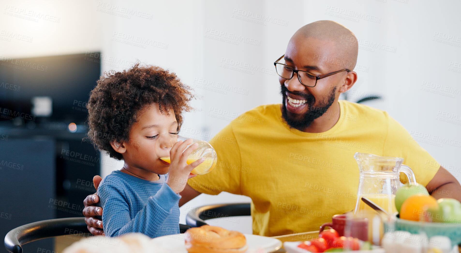 Buy stock photo Juice, breakfast and father eating and drinking with child in dining room at home together for bonding. Smile, love and African dad enjoying healthy morning food with boy kid at family house.