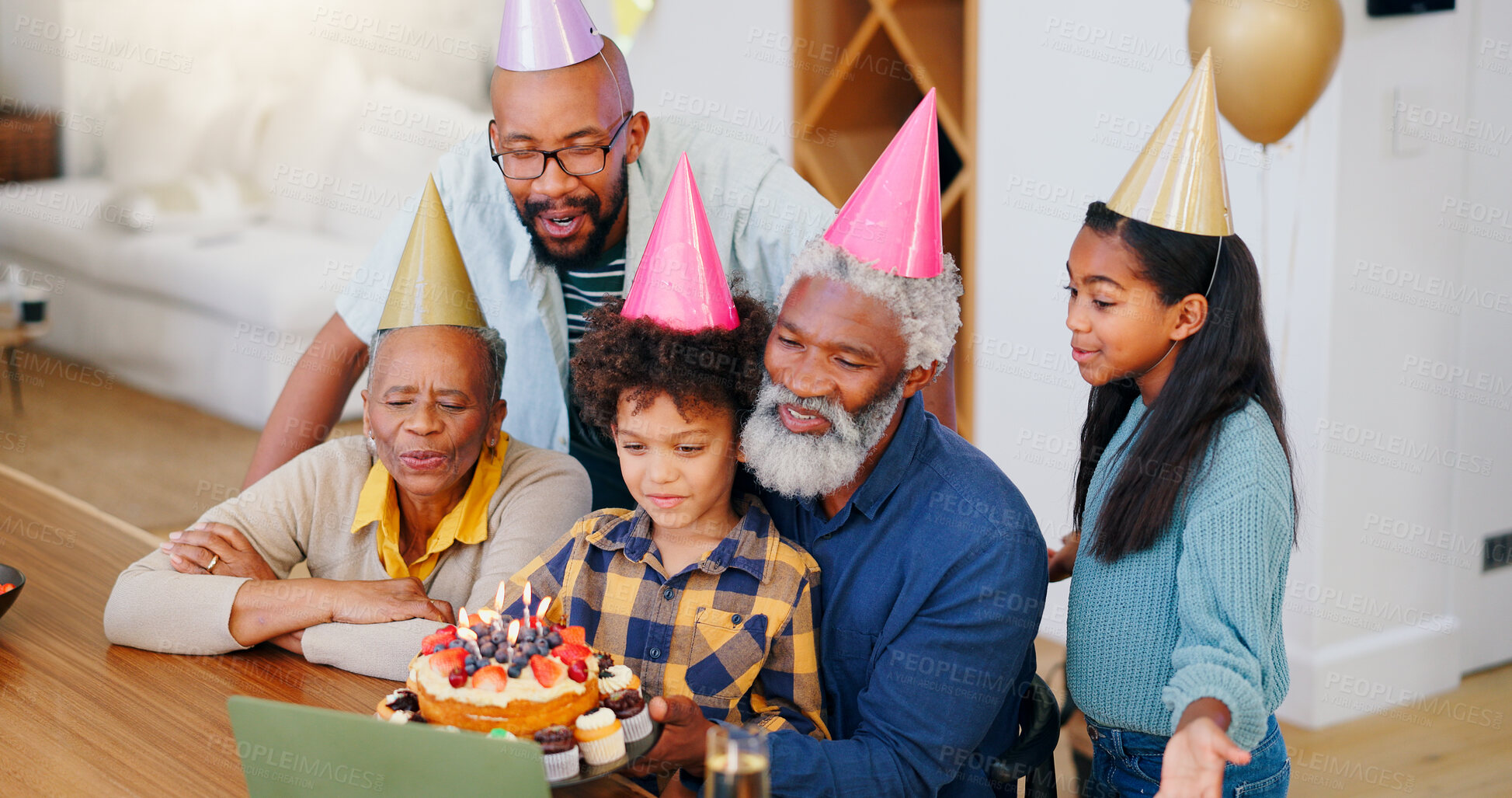 Buy stock photo Video call, laptop and family at birthday party celebration together at modern house with candles and cake. Smile, love and young children with African father and grandparents for dessert at home.