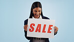 Happy woman, sale and sign for discount, advertising or deal against a blue studio background. Excited female person with billboard, poster or wow for marketing, promotion or special on mockup space