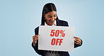 Excited woman, sale and sign for discount, advertising or deal against a blue studio background. Happy female person with billboard or poster for marketing, half price or special promotion on mockup