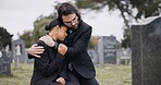 Sad couple, graveyard and hug in loss, grief or mourning together at funeral, tombstone or cemetery. Man holding woman in comfort, empathy or goodbye at memorial or burial service for death on grass