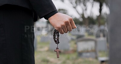 Rosary, death or hand cemetery for funeral. spiritual service or grave visit to repsect the Christian religion. Mourning, goodbye or closeup of person outside in graveyard for grief, loss or farewell