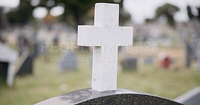 Funeral, graveyard and cross on tombstone for death ceremony, religion or memorial service. Catholic symbol, background or Christian sign on gravestone for mourning, burial or loss in public cemetery