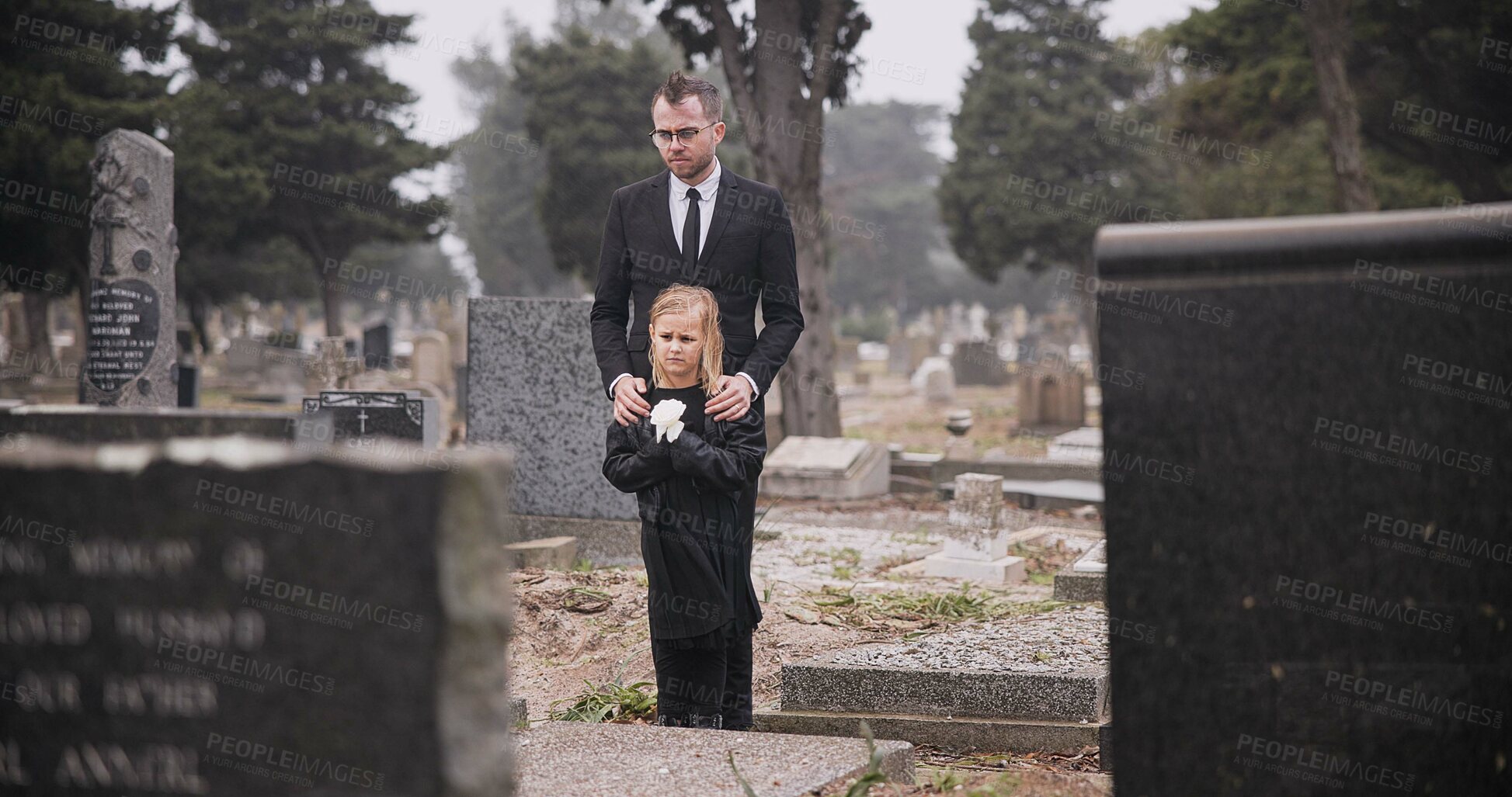 Buy stock photo Child, death or father in graveyard for funeral. spiritual service or burial for respect in Christian religion. Rose, depressed or sad kid in cemetery for grief, loss or mourning with dad for support