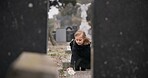 Flower, death or kid in cemetery for funeral. spiritual service or tombstone for respect in Christian religion. Mourning, sad or depressed girl child outside in graveyard for grief, loss or farewell