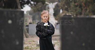 Buy stock photo Flower, death or kid in cemetery for funeral. spiritual service or grave visit for repsect in Christian religion. Mourning, goodbye or sad girl child outside in graveyard for grief, loss or farewell