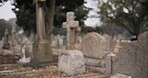 Funeral, empty graveyard and tombstones for death ceremony, religion or memorial service. Catholic symbol, background or Christian sign on gravestone for mourning, burial or loss in public cemetery