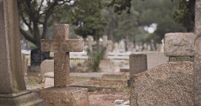 Funeral, cemetery and cross on tombstone for death ceremony, religion or memorial service. Catholic symbol, background or Christian sign on gravestone for mourning, burial or loss in public graveyard