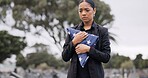 Funeral, death and american flag with a woman in a graveyard for mourning during a memorial service. Sad, usa and an army wife as a lonely widow at a cemetery feeling the pain of loss or grief