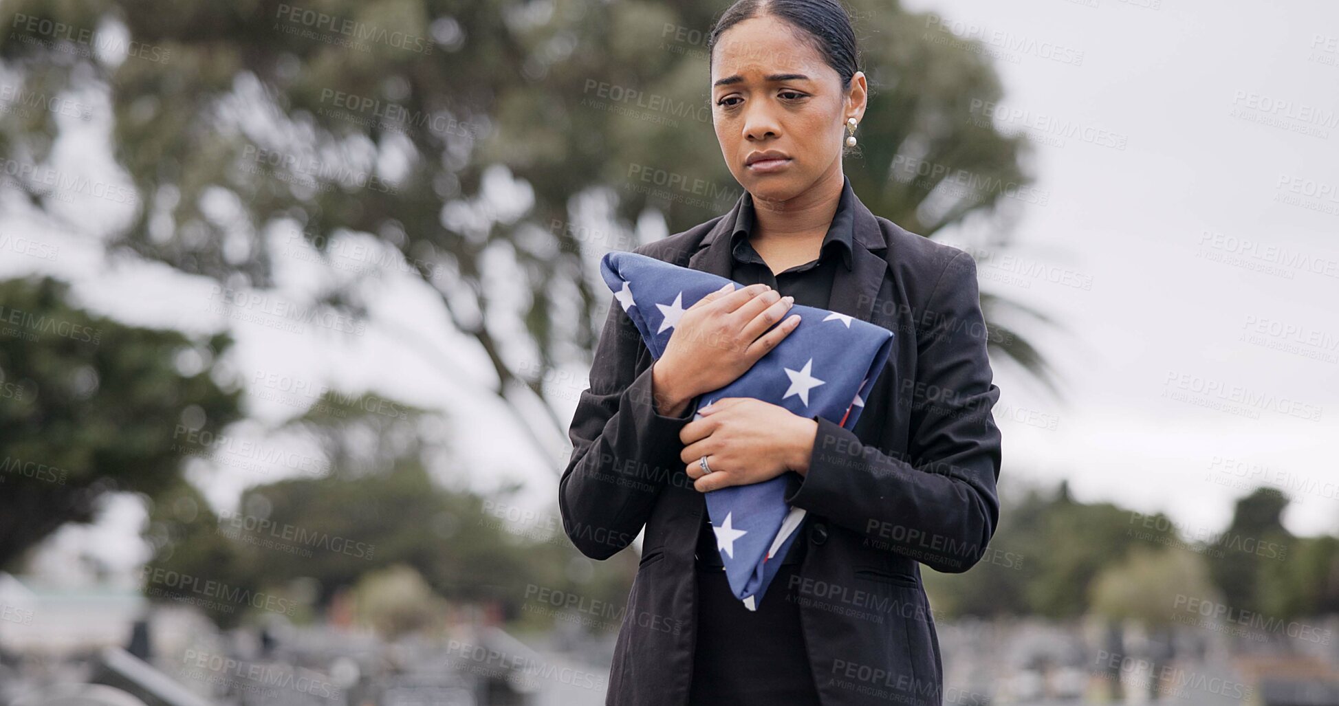 Buy stock photo Funeral, death and american flag with a woman in a graveyard for mourning during a memorial service. Sad, usa and an army wife as a lonely widow at a cemetery feeling the pain of loss or grief