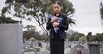 Funeral, death and a sad woman with an american flag at a cemetery in mourning at a memorial service. Sad, usa and an army wife as a widow in a graveyard alone feeling the pain of loss or grief