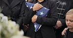 Funeral, cemetery and woman with American flag for veteran for respect, ceremony and memorial service. Family, depression and sad people by coffin in graveyard for military, army and soldier mourning