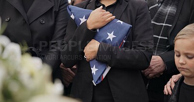 Buy stock photo Funeral, cemetery and woman with American flag for veteran for respect, ceremony and memorial service. Family, depression and sad people by coffin in graveyard for military, army and soldier mourning