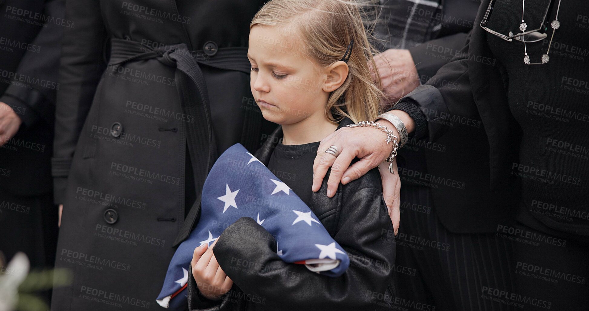 Buy stock photo Funeral, cemetery and girl with American flag for veteran for respect, ceremony and memorial service. Family, depression and sad child by coffin in graveyard mourning military, army and soldier hero