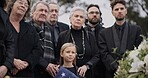 Funeral, cemetery and family with American flag for veteran for respect, ceremony and memorial service. Sad, depression and people by coffin in graveyard for military hero, army and soldier mourning