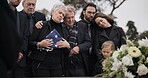 Funeral, cemetery and family with American flag for soldier for respect, ceremony and memorial service. Sad, depression and people by coffin in graveyard mourning military, army and veteran hero