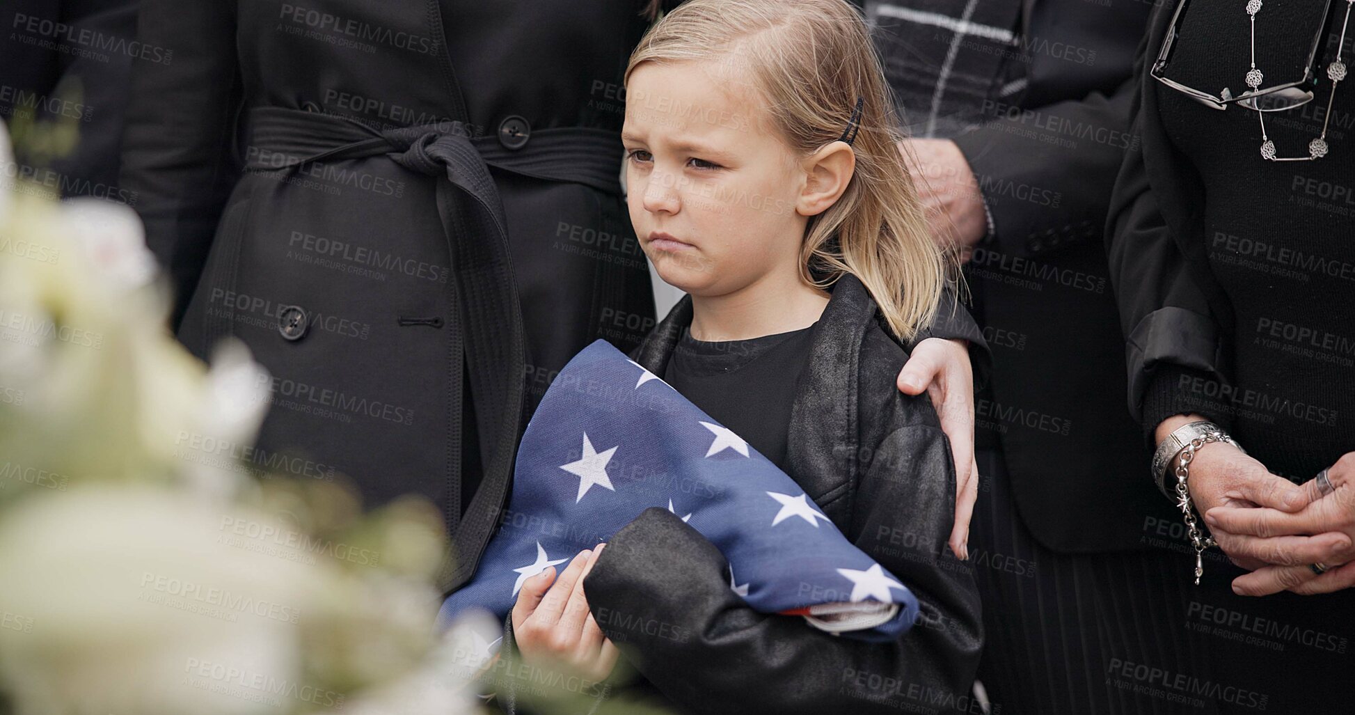 Buy stock photo Funeral, cemetery and child with American flag for veteran for respect, ceremony and memorial service. Family, depression and sad girl by coffin in graveyard mourning military, army and soldier hero