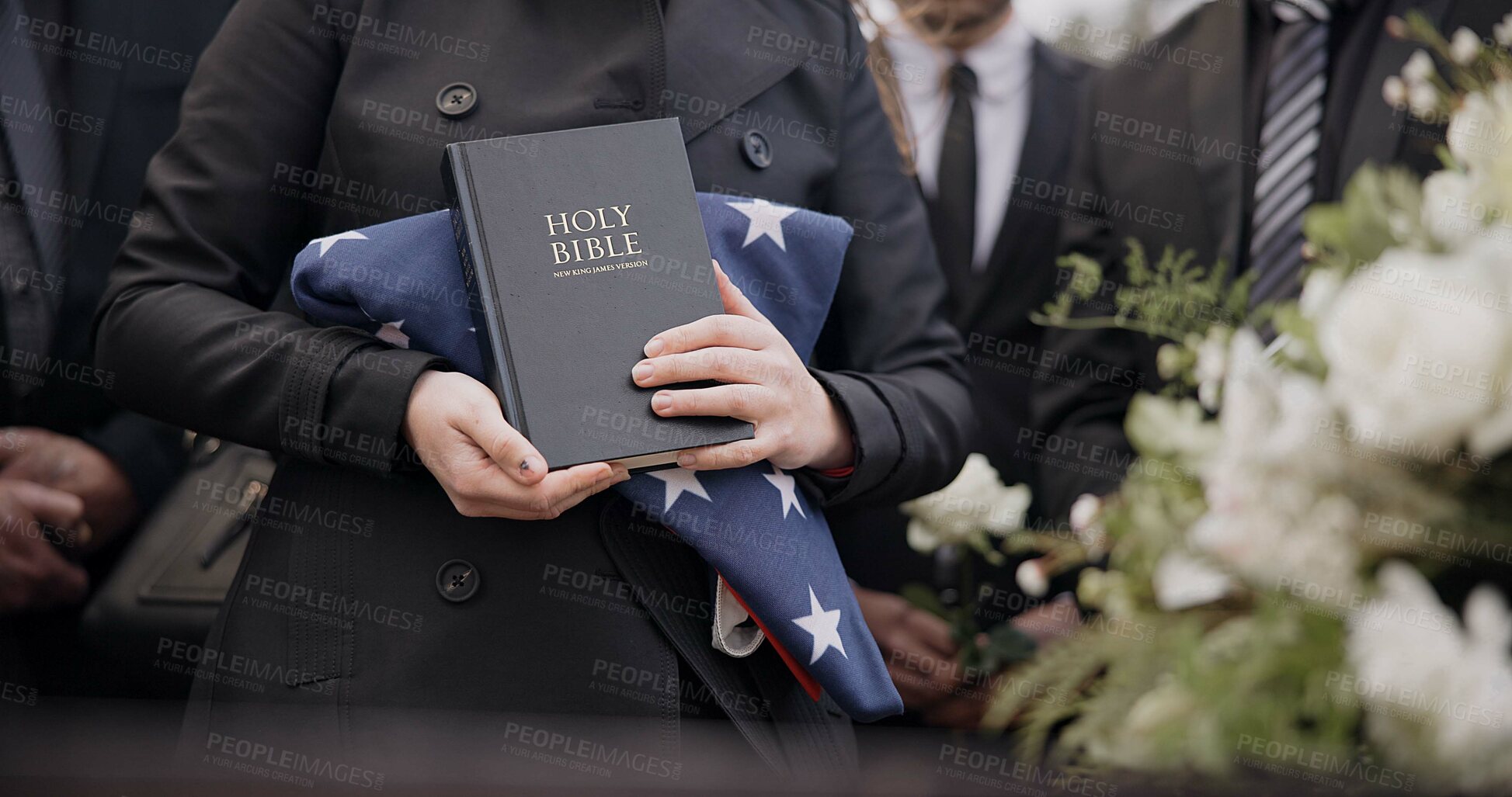 Buy stock photo Hands, american flag and bible with a person at a funeral, grieving a loss at a graveyard. War, cemetery and death with an army wife at a memorial service to say goodbye to a fallen soldier closeup