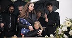 Funeral, family and sad people with American flag, grief and mourning death, burial and widow depressed at farewell event. Kid, mother and group gathering at coffin, casket and crying at ceremony