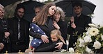 Funeral, family hug and sad people with grief support, goodbye service and mourning death at burial event. Kid child, mom embrace and group gathering together at coffin, casket and crying at ceremony