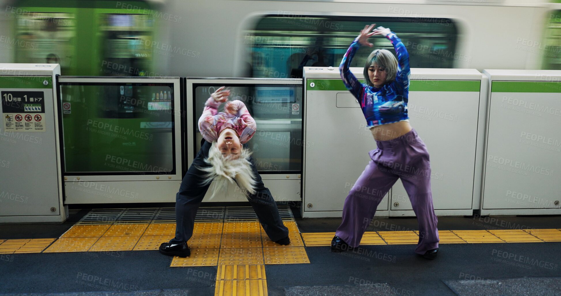 Buy stock photo Asian woman, dancing and railway station by train for energy, art or underground performance in subway. Female person, friends or hip hop dancers in Japan, practice or training together by transport