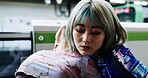 Japanese women, friends hug and city by train station with care, kindness and bonding on vacation. Girl, embrace and love in metro for transportation, travel or gen z fashion with streetwear in Tokyo