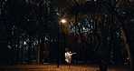 Ballet, dance and night or outdoor performance at park street lamp or outdoor, practice or creative artist. Female person, leg and dress on pointe in Japanese garden or talent, entertainment or skill